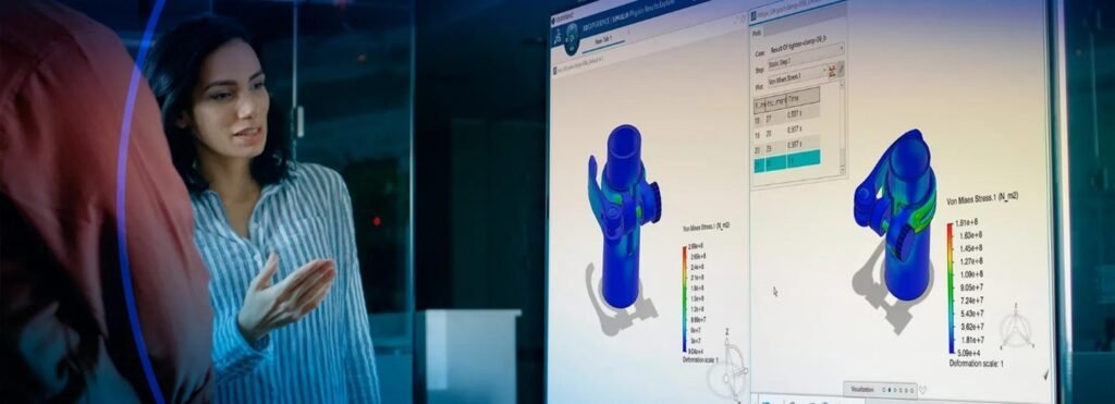 A woman in a professional setting discusses structural simulation results displayed on a large screen.